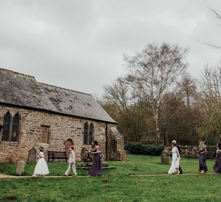 Bride and bridesmaids walking into church