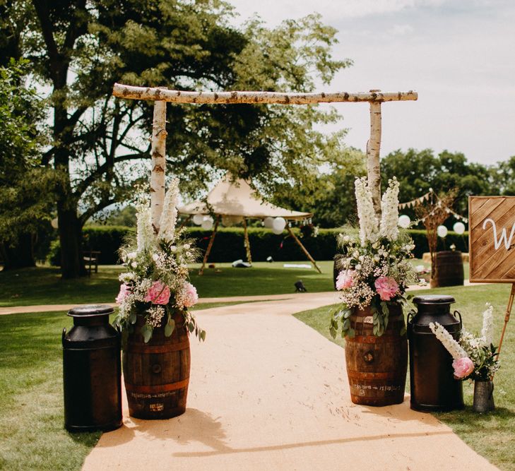 Welcome Entrance with Milk Churns, Barrels, &amp; Wooden Arch &amp; Sign | DIY Rustic Tipi Wedding at Riverhill Gardens, Sevenoaks | Frances Sales Photography