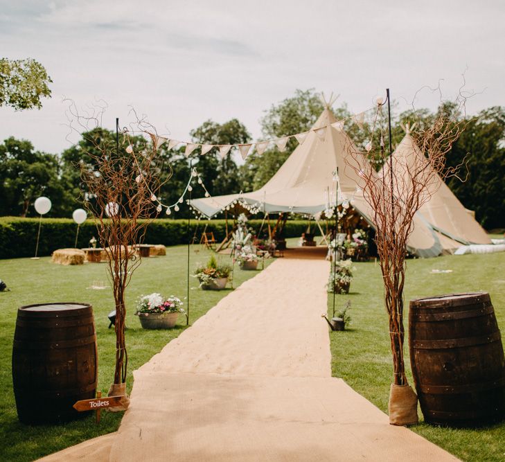 Tipi Entrance with Barrels &amp; Bunting &amp; Festoon Lights  | DIY Rustic Tipi Wedding at Riverhill Gardens, Sevenoaks | Frances Sales Photography