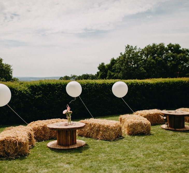 Hay Bale Seating Area with Giant Balloon Wedding Decor | DIY Rustic Tipi Wedding at Riverhill Gardens, Sevenoaks | Frances Sales Photography