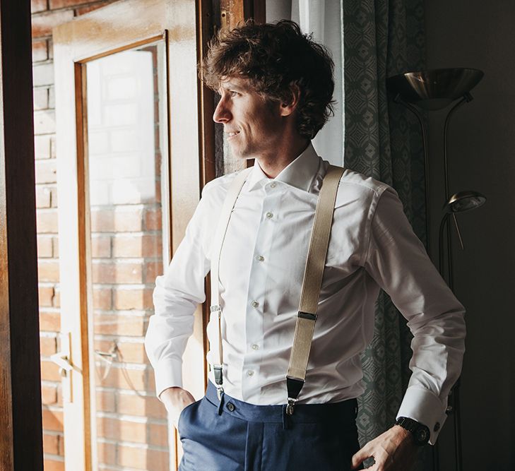 Groom in Navy Suit and Braces