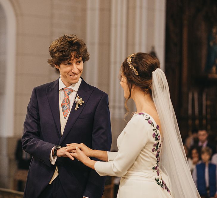 Church Wedding Ceremony with Bride in Nnavascues Embroidered Back Wedding Dress and Groom in Navy Suit Saying Their Vows at the  Altar