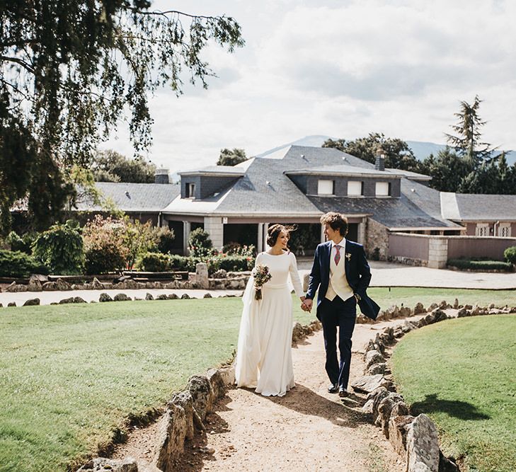 Bride in Nnavascues Embroidered Back Wedding Dress and Groom in Navy Suit