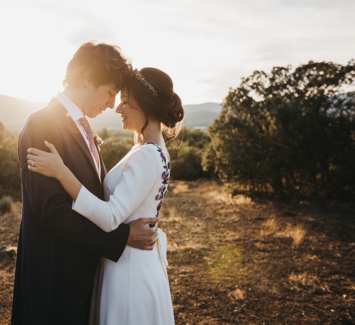 Golden Hour Portrait of Bride in Nnavascues Embroidered Back Wedding Dress and Groom in Navy Suit