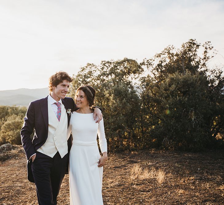 Bride in Nnavascues Embroidered Back Wedding Dress and Groom in Navy Suit