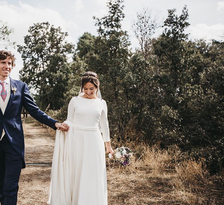 Bride in Nnavascues Embroidered Back Wedding Dress and Groom in Navy Suit