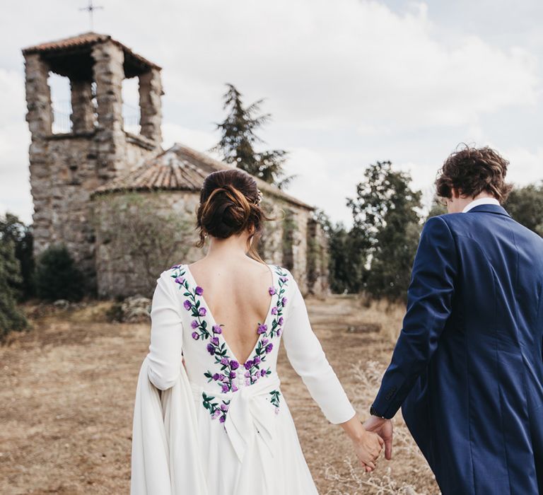 Bride in Nnavascues Embroidered Back Wedding Dress and Groom in Navy Suit