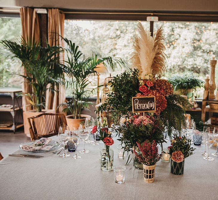 Wedding Reception Floral Centrepiece with Pink Flowers and Dried Grasses