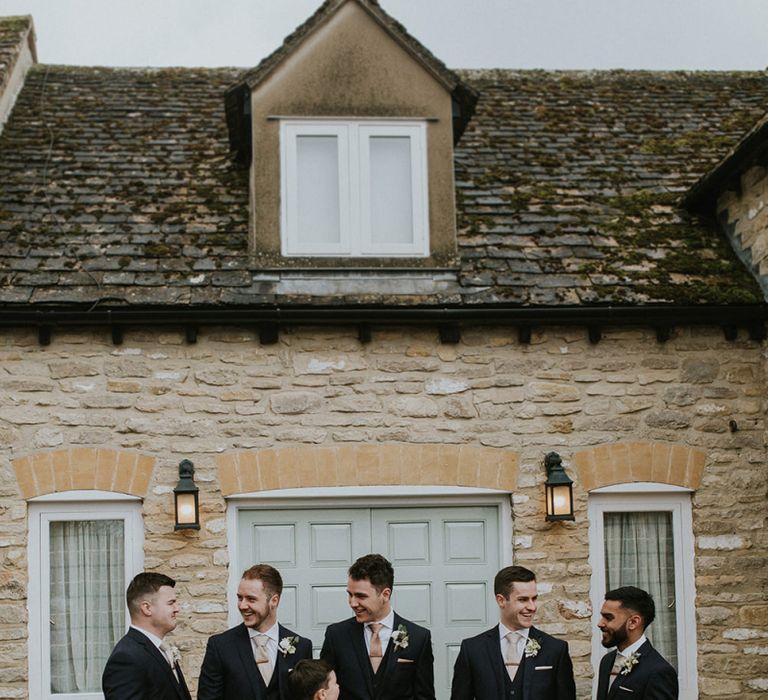 Groomsmen in Black Moss Bros. Suits