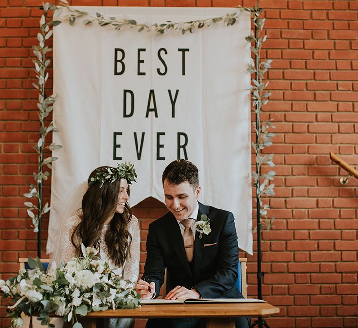 Church Wedding Ceremony with Bride and Groom Kissing Signing Register in Front of Best Day Ever Sign