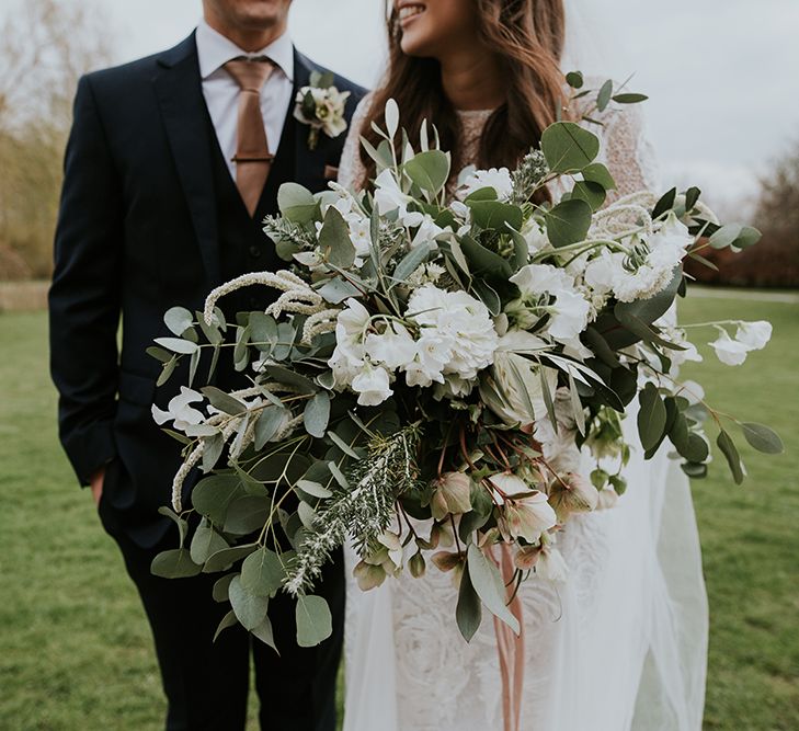 Boho Bride Holding an Oversized White Flower and Foliage Wedding Bouquet