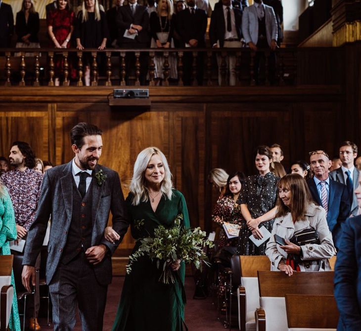 Bridesmaid wearing emerald green dress and foliage bouquet at Stoke Newington Town Hall wedding