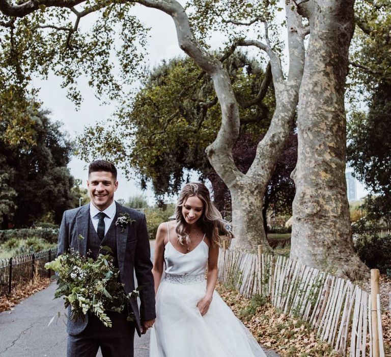 Bride wearing two piece dress and groom wearing three piece 'Peaky Blinder' style suit