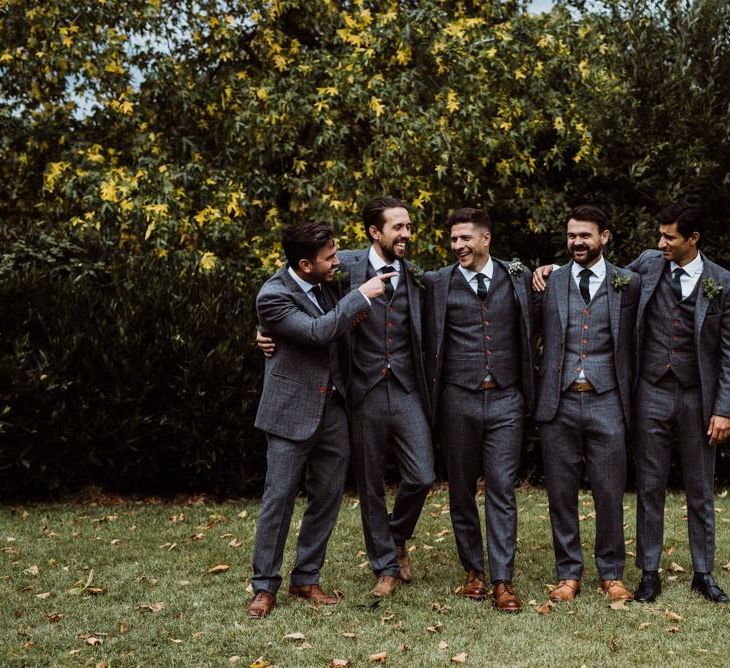 Groom and his groomsmen wearing grey three piece suits with brown shoes at 'Peaky Blinder' styled wedding