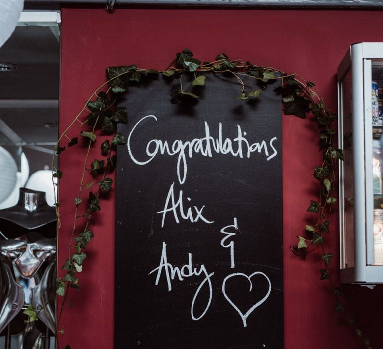 Chalkboard wedding sign at pub reception