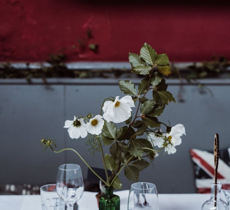 Glass vases with floral centrepieces at pub reception