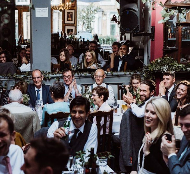 Guests raise a glass at pub reception for a relaxed party celebration