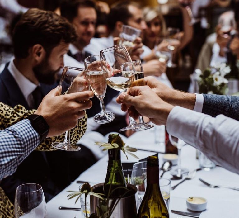 Guests raise a glass at pub reception for a relaxed party celebration