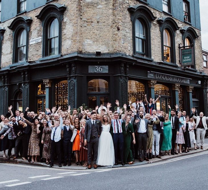 Bride and groom celebrate with their guests at pub reception