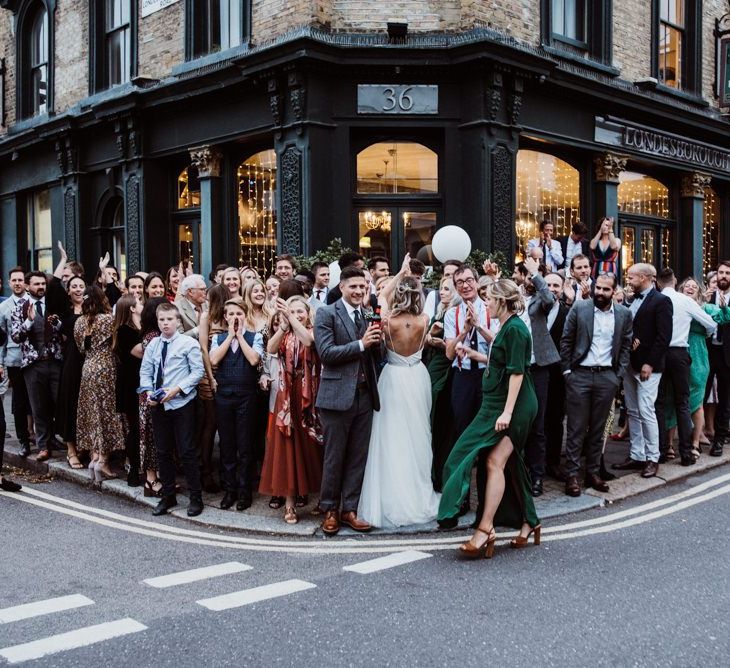 Bride and groom celebrate with their guests at pub reception