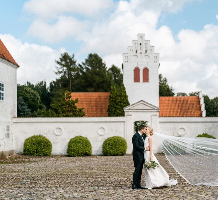 Bride in Caroline Castigliano Wedding Dress | Groom in Henry Herbert Tailors Morning Suit | Traditional Green/Blue Danish Wedding at Scandinavian Country House, Jomfruens Egede in Faxe, Denmark | John Barwood Photography