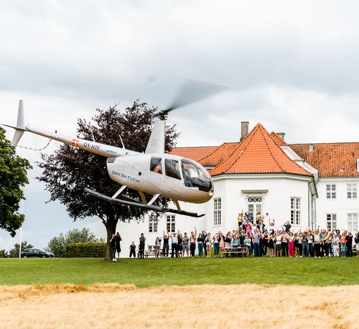 Helicopter Entrance | Traditional Green/Blue Danish Wedding at Scandinavian Country House, Jomfruens Egede in Faxe, Denmark | John Barwood Photography