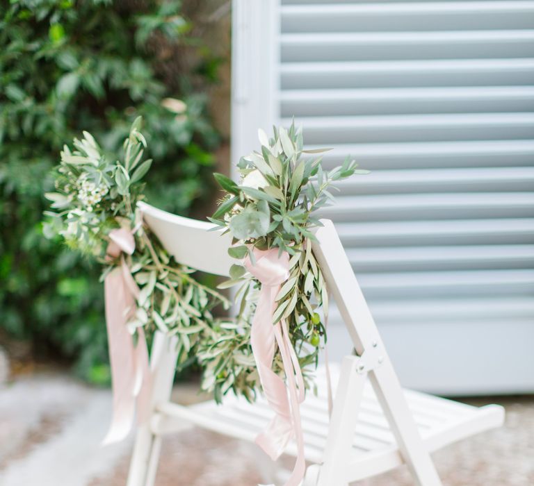 Greenery Garland Chair Back Decor with Pink Ribbon | Four Day Italian Destination Wedding at Frattoria Mansi Bernadini Planned by Weddings by Emily Charlotte | Cecelina Photography