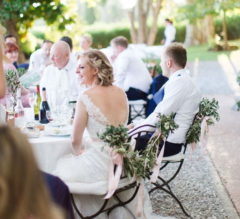 Greenery Garland Chair Back Decor | Bride in Lace Stella York Wedding Dress | Groom in Three Piece Navy Suit | Four Day Italian Destination Wedding at Frattoria Mansi Bernadini Planned by Weddings by Emily Charlotte | Cecelina Photography