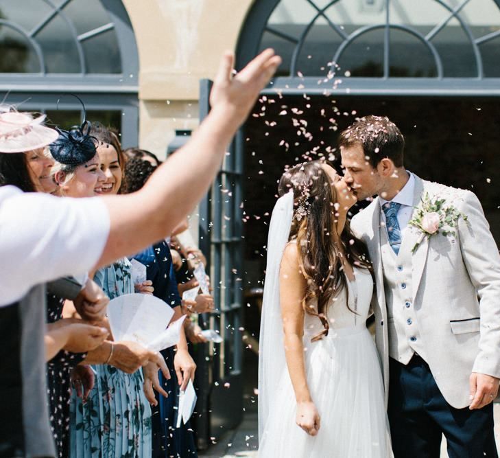 Confetto Moment with Bride in Catherine Deane Wedding Dress and Groom in Beige Blazer