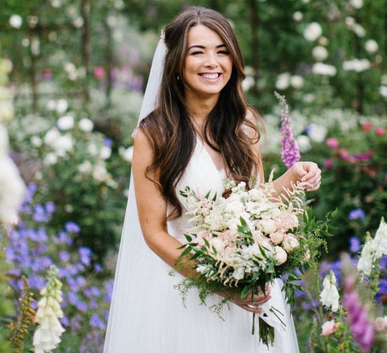 Bride in Catherine Deane Wedding Dress Holding Her Pastel Flower Wedding Bouquet