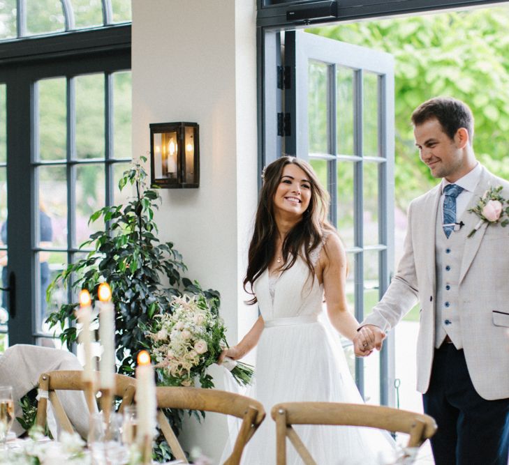 Bride and Groom Entering the Wedding Breakfast with Acrylic Wedding Signs