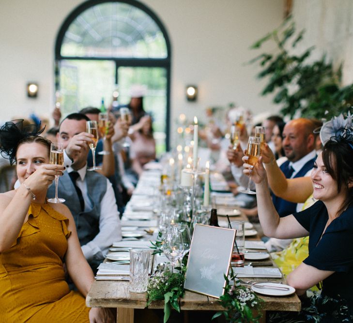 Wedding Guests Raising a Glass During the Middleton Lodge Wedding Breakfast with Frosted Acrylic Wedding Signs