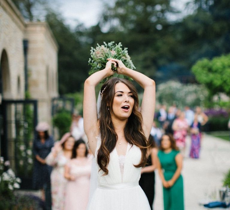 Bride in Catherine Deane Wedding Dress about to toss the bridal bouquet