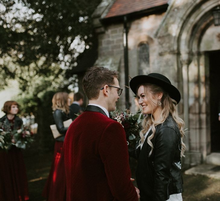 Bride and Groom Smiling at Each Other Outside the Church