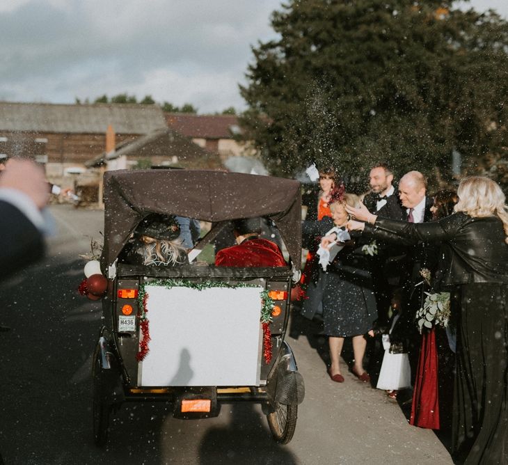 Bride and Groom in a Tuc Tuc with White Confetti Thrown Over Them