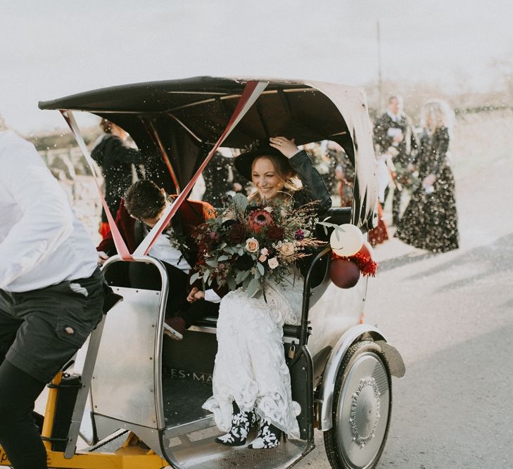 Bride and Groom in a Tuc Tuc with White Confetti Thrown Over Them