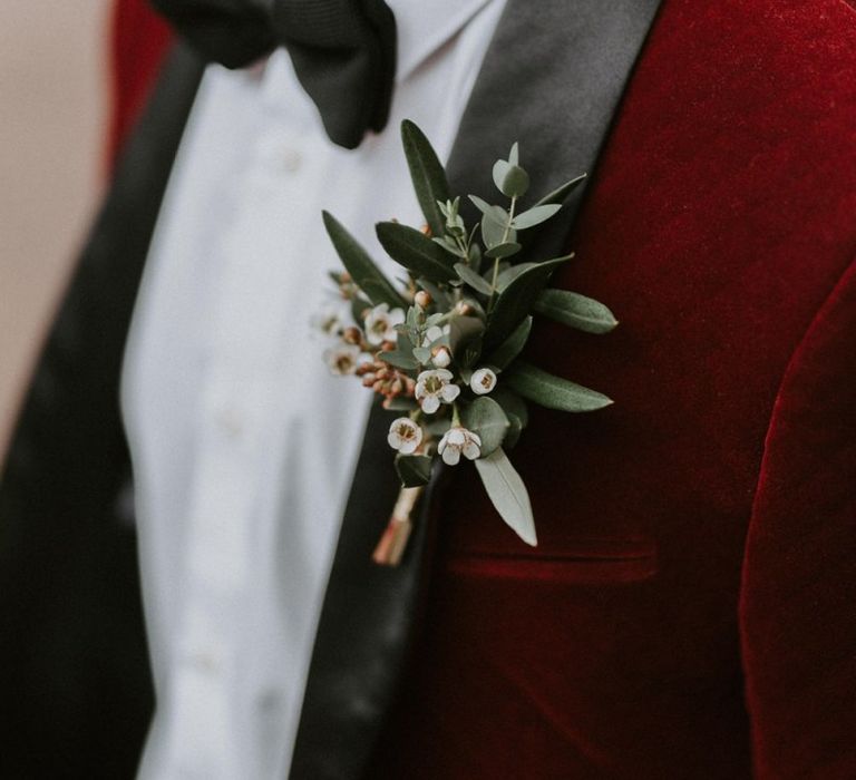 Groom in Red Velvet Tuxedo Jacket with White and Green Buttonhole