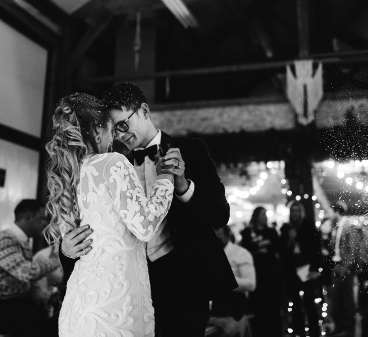 First Dance with Bride in Phase Eight Wedding Dress and Groom in Tuxedo Under a Snow Machine