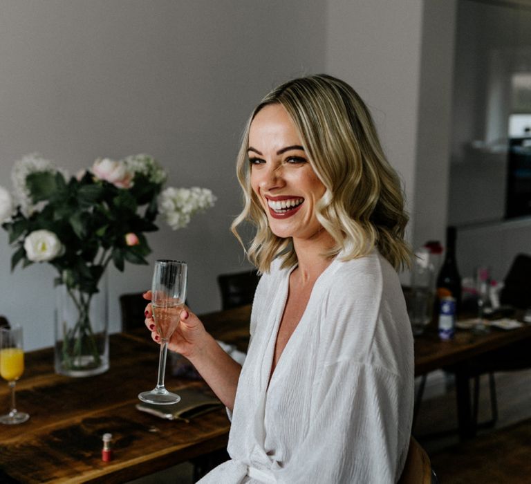 Bride with wavy bobbed hair and dark lipstick on wedding morning