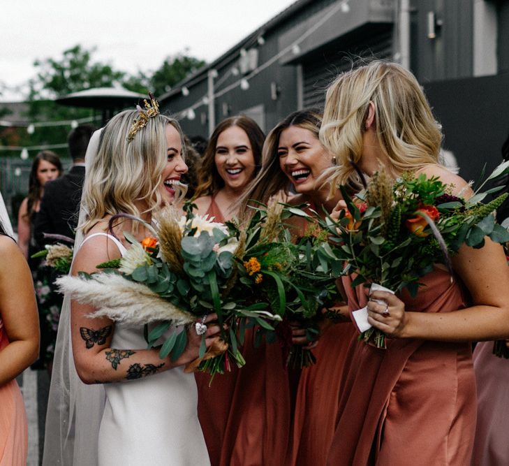 Bride and bridesmaids laughing together