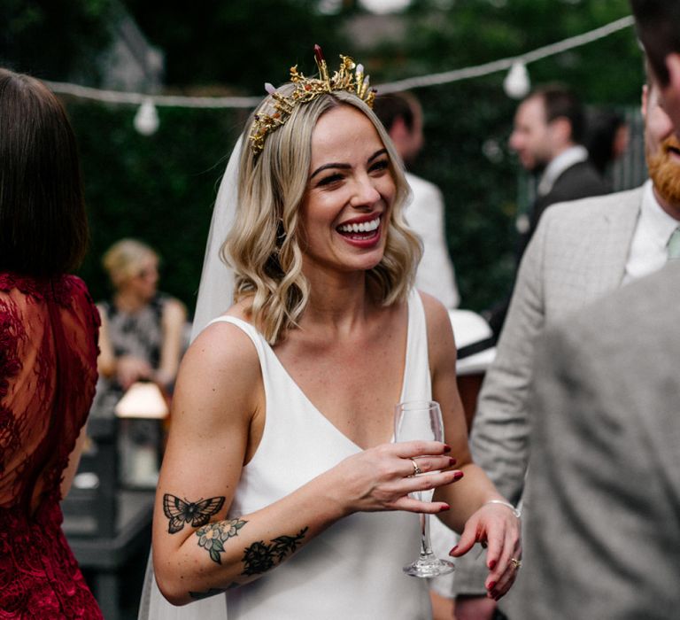 Stunning bride with tattoos in gold bridal crown