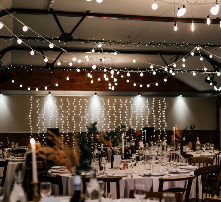 Festoon and fairy light decor at industrial wedding venue