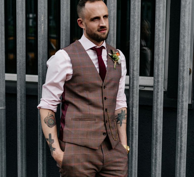 Groom in brown check trousers and waistcoat