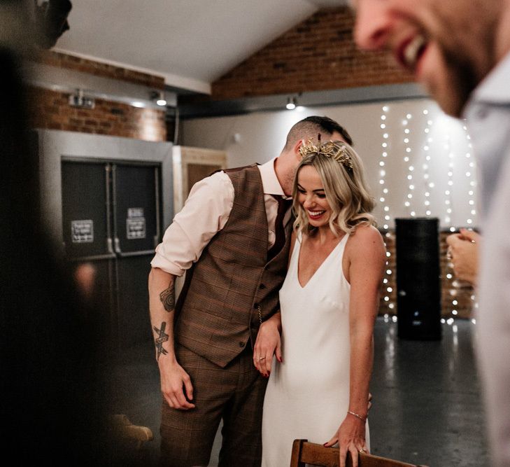 Groom whispering something in his brides ear