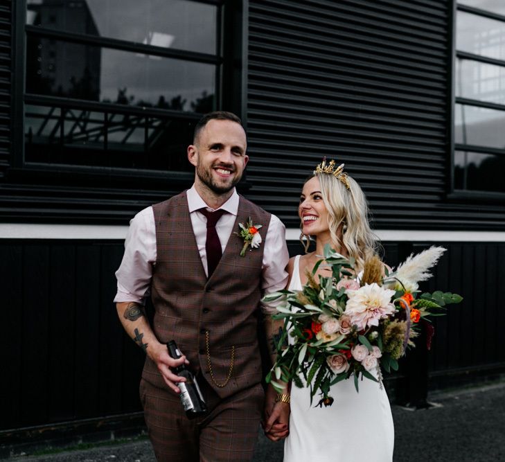 Stylish bride and groom with tattoos