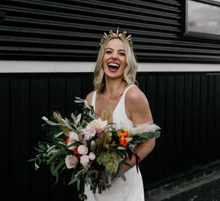 Bride in gold bridal crown laughing