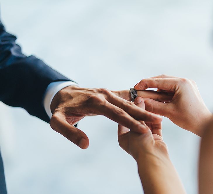 Bride Putting on Grooms Wedding Band