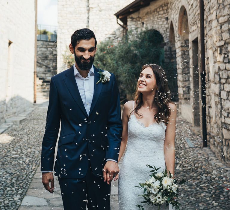 Just Married Confetti Moment with Bride in Grace Loves Lace Mia Wedding Dress and Groom in Taliare Navy Suit