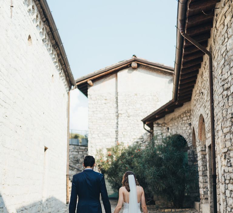 Bride in Grace Loves Lace Mia Wedding Dress and Groom in Taliare Navy Suit