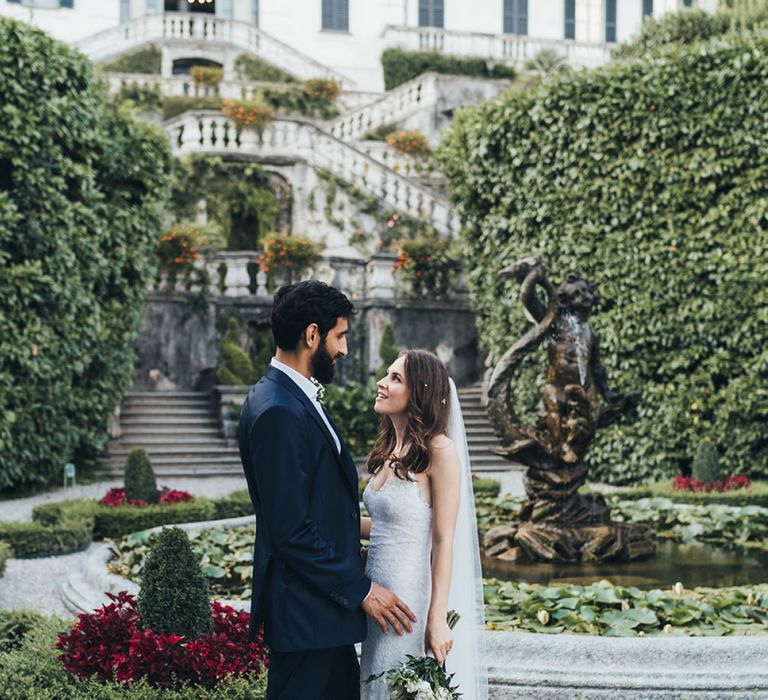 Portrait of Bride in Grace Loves Lace Mia Wedding Dress and Groom in Taliare Navy Suit